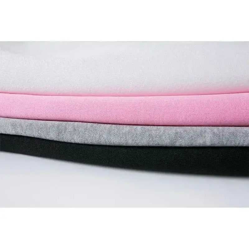 Stack of fabric swatches in gray, pink, and black on a white background
