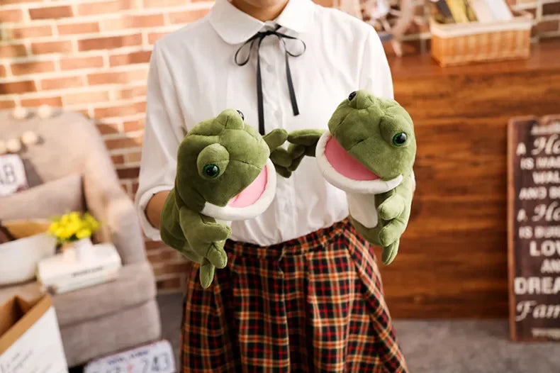 Person holding two green frog plush toys in a casual indoor setting