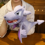 Person holding a plush shark toy on a wooden surface