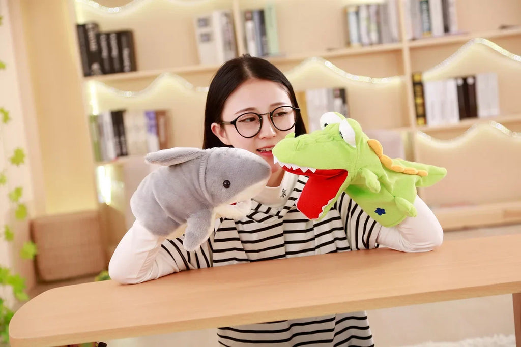 Person holding a shark and dinosaur plush toy in a room with bookshelves.